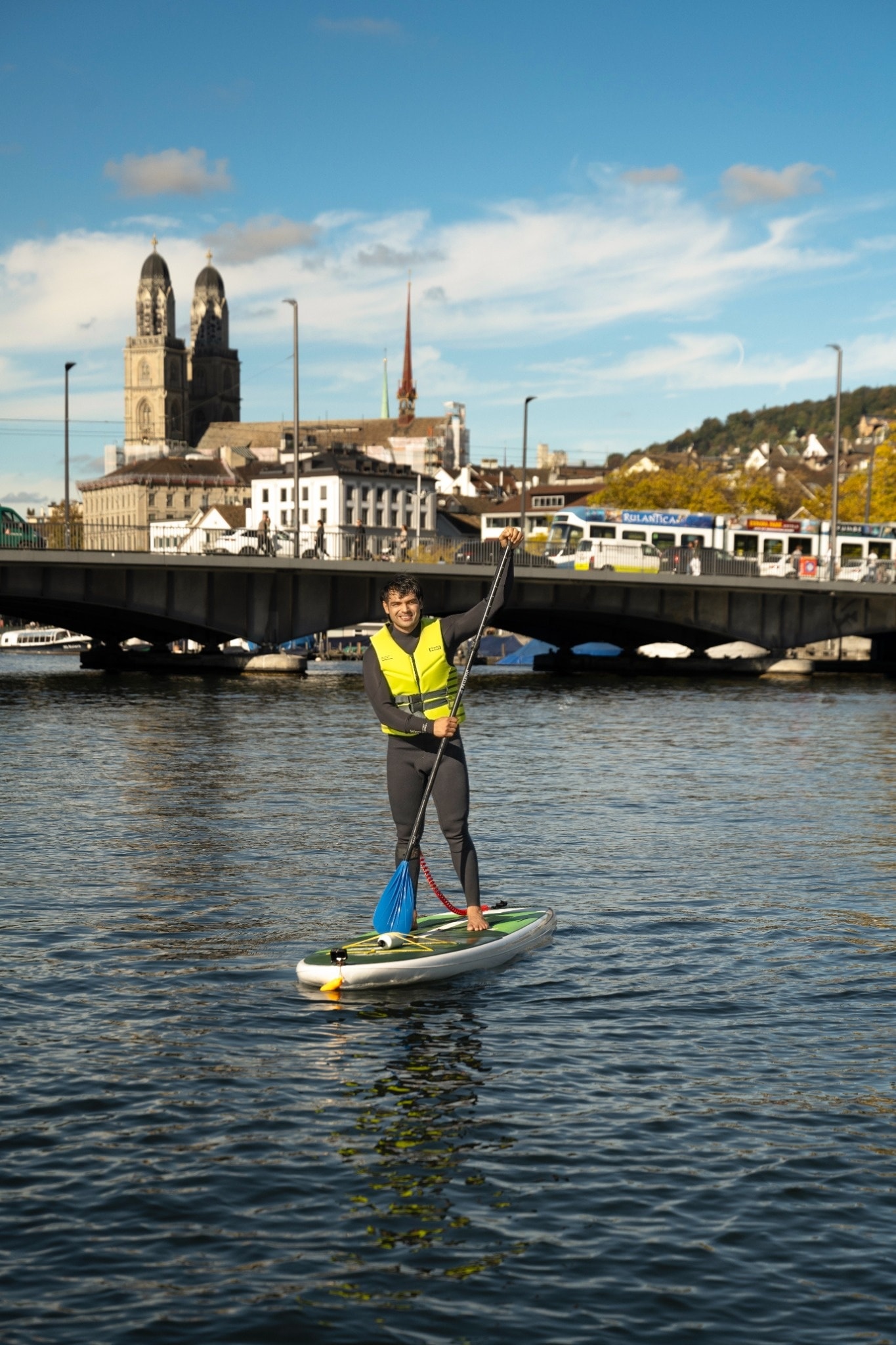 Neeraj Chopra paddleboards on Lake Zürich, with the city skyline and the twin towers of Grossmünster rising behind him Neeraj Chopra paddleboards on Lake Zürich, with the city skyline and the twin towers of Grossmünster rising behind him