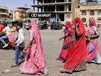 People shield themselves on a warm day in Jaisalmer, Rajasthan, earlier this week. (PTI) People shield themselves on a warm day in Jaisalmer, Rajasthan, earlier this week. (PTI)