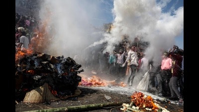 Devotees dance in front of a burning funeral pyre as they take part in the 'Masaan' or 'Bhasma' Holi, celebrated with ashes of the pyre, along the banks of the river Ganges at Harishchandra Ghat in Varanasi (AFP) Devotees dance in front of a burning funeral pyre as they take part in the 'Masaan' or 'Bhasma' Holi, celebrated with ashes of the pyre, along the banks of the river Ganges at Harishchandra Ghat in Varanasi (AFP)