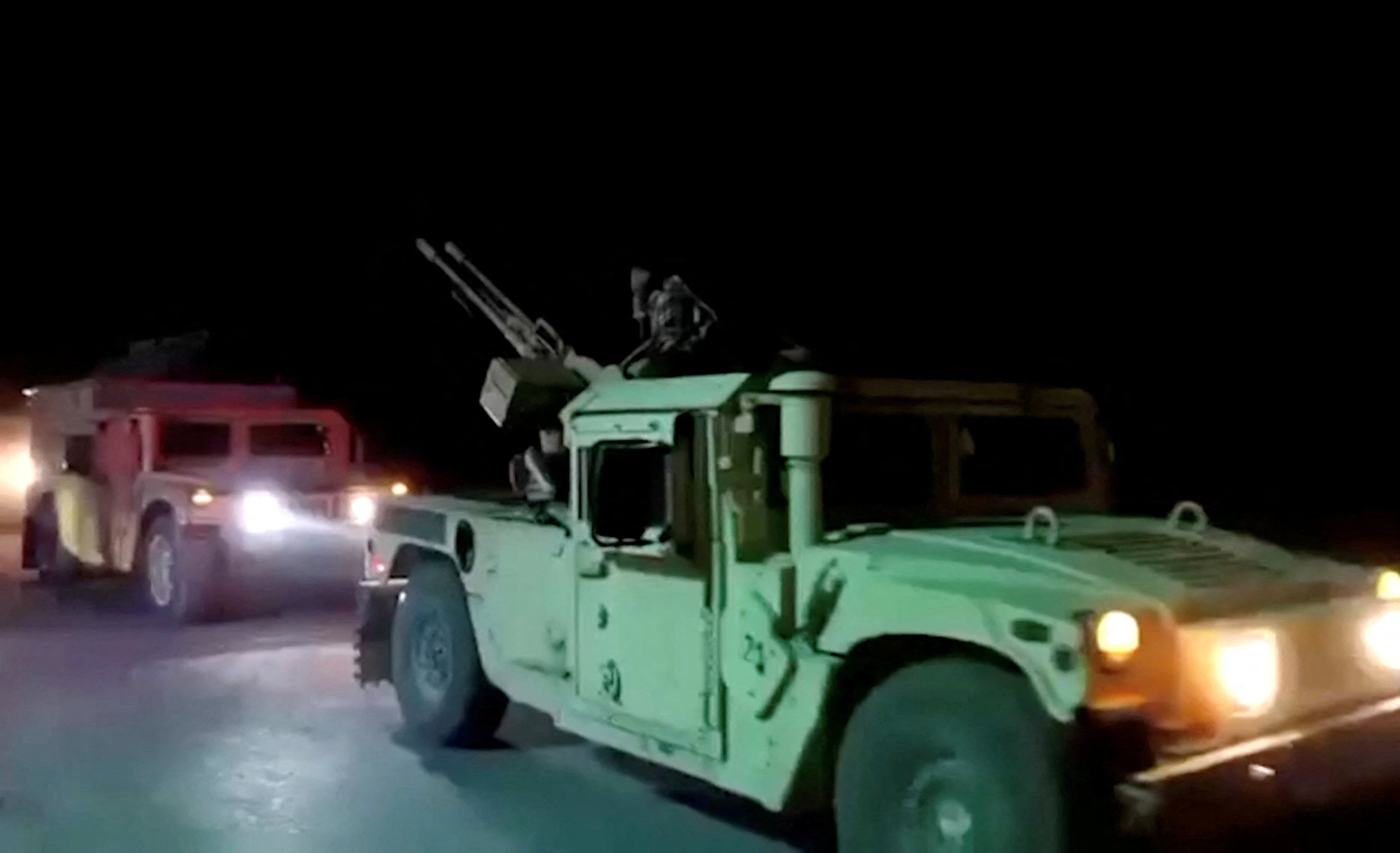 Military vehicles move on a road in a location given as Nangarhar, Afghanistan, in this screengrab from a handout video released on February 26, 2026. (REUTERS)