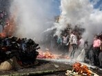 Devotees dance in front of a burning funeral pyre as they take part in the 'Masaan' or 'Bhasma' Holi, celebrated with ashes of the pyre, along the banks of the river Ganges at Harishchandra Ghat in Varanasi (AFP)