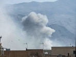 A plume of smoke rises following a reported explosion in Tehran. 
