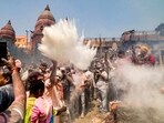 People take part in 'Holi' celebration at Manikarnika Ghat, in Varanasi, on Saturday. (PTI)