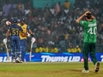 Sri Lanka's Pavan Rathnayake celebrates his fifty runs with captain Dasun Shanaka,