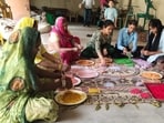 Women associated with self-help groups making eco-friendly abeer and gulal from Palash flowers in Prayagraj. (HT photo)