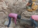 Workers repairing a broken sewer pipeline in Preetam Nagar locality of Prayagraj on Friday. (HT PHOTO)