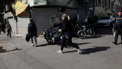 People run for cover following an explosion, after Israel said it launched a pre-emptive attack against Iran. (Reuters)