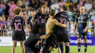 A fan who got onto the field grabs Inter Miami's Lionel Messi. (AP) A fan who got onto the field grabs Inter Miami's Lionel Messi. (AP)