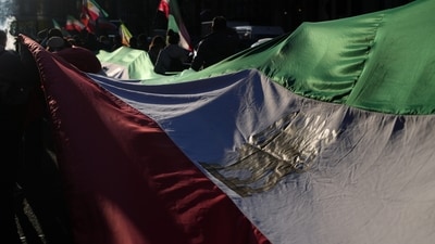 Protesters carry a flag during a rally in London, Saturday, Feb. 28, 2026 after U.S. and Israeli forces carried out a series of strikes on Iran on Saturday morning. (AP Photo/Alastair Grant) (AP) Protesters carry a flag during a rally in London, Saturday, Feb. 28, 2026 after U.S. and Israeli forces carried out a series of strikes on Iran on Saturday morning. (AP Photo/Alastair Grant) (AP)