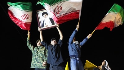 Supporters of Iraqi Shi'ite armed groups wave Iranian flags as they gather near the entrance of Baghdad's Green Zone to show support for Iran, amid heightened regional tensions following recent attacks and retaliatory strikes between Iran and U.S. forces, in Baghdad, Iraq, February 28, 2026. REUTERS/Ahmed Saad (REUTERS)