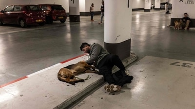 A man pets his dog as he takes shelter in an underground parking garage in Tel Aviv on February 28, 2026. The United States and Israel launched strikes against Iran on February 28, with Israel's public broadcaster reporting that the Iranian supreme leader had been targeted, as the Islamic republic retaliated with barrages of missiles at Gulf states and Israel. (Photo by JOHN WESSELS / AFP) (AFP) A man pets his dog as he takes shelter in an underground parking garage in Tel Aviv on February 28, 2026. The United States and Israel launched strikes against Iran on February 28, with Israel's public broadcaster reporting that the Iranian supreme leader had been targeted, as the Islamic republic retaliated with barrages of missiles at Gulf states and Israel. (Photo by JOHN WESSELS / AFP) (AFP)
