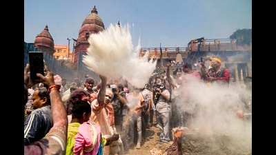 People take part in 'Holi' celebration at Manikarnika Ghat, in Varanasi, on Saturday. (PTI) People take part in 'Holi' celebration at Manikarnika Ghat, in Varanasi, on Saturday. (PTI)