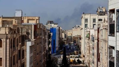 A plume of smoke rises following a reported explosion in Tehran, after two loud blasts were heard in Tehran on the morning of February 28. (AFP)