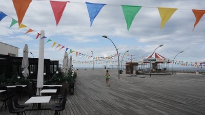 A woman runs on empty boardwalk at the Tel Aviv, Israel, port after alarms announced that Israel had launched an attack on Iran on Saturday (AP)