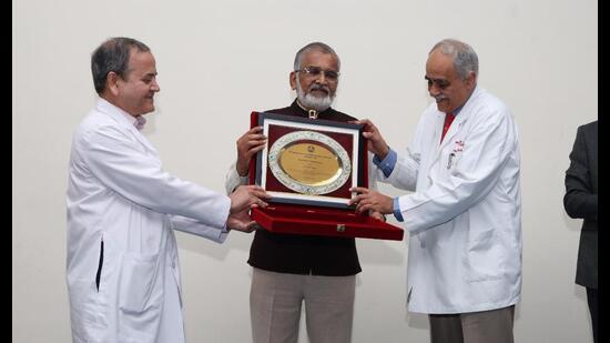 Dr Abhay Bang being honoured at PGIMER. (HT)