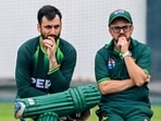 Pakistan's captain Salman Agha (L) speaks with head coach Mike Hesson during a training session