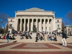 Students relax on the front steps of Low Memorial Library on the Columbia University campus, in New York City