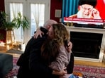 Iranian American community members and supporters of the National Council of Resistance of Iran Sadaf Ebrahimi, Shirin Nariman, and Mehran Ebrahimi react to news reports on U.S. President Donald Trump's announcement that Iran's Supreme Leader Ayatollah Ali Khamenei was killed in joint U.S. and Israeli strikes, at Nariman's home in Vienna, Virgina U.S. February 28, 2026. REUTERS/Nathan Howard REFILE - ADDING "SUPREME LEADER AYATOLLAH ALI KHAMENEI".