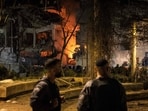Israeli security forces stand in front of the site of an Iranian missile strike in Tel Aviv on February 28, 2026. 