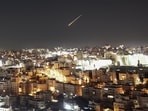 TOPSHOT - An Iranian projectile leaves a trail in the sky as seen from the Israeli-occupied West Bank city of Hebron early on March 1, 2026. US President Donald Trump said on February 28 that Iran's supreme leader Ayatollah Ali Khamenei was dead, after Israel and the United States launched an attack of unprecedented scale aimed at bringing down the Islamic republic. (Photo by HAZEM BADER / AFP)