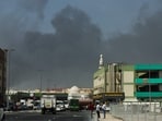 People look at thick smoke rising from the site of a reported Iranian strike in Dubai on March 1, 2026. 