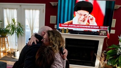 Iranian American community members and supporters of the National Council of Resistance of Iran Sadaf Ebrahimi, Shirin Nariman, and Mehran Ebrahimi react to news reports on U.S. President Donald Trump's announcement that Iran's Supreme Leader Ayatollah Ali Khamenei was killed in joint U.S. and Israeli strikes, at Nariman's home in Vienna, Virgina U.S. February 28, 2026. REUTERS/Nathan Howard REFILE - ADDING "SUPREME LEADER AYATOLLAH ALI KHAMENEI". (REUTERS)