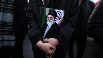 A man holds a poster of Khamenei, who was killed in joint US and Israeli strikes, as he joins other mourners at a square in Tehran on March 1, 2026. (AFP) A man holds a poster of Khamenei, who was killed in joint US and Israeli strikes, as he joins other mourners at a square in Tehran on March 1, 2026. (AFP)