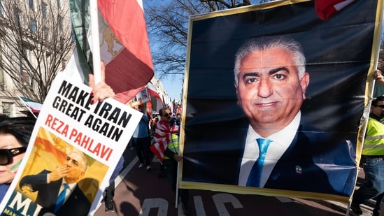 Demonstrators carry a photograph of Reza Pahlavi as people who support the US and Israel strikes on Iran, rally near the White House in Washington. (AP)