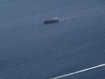Boats in the Strait of Hormuz amid the U.S.-Israeli conflict with Iran, as seen from Musandam, Oman, on March 2 (REUTERS)