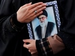 A woman holds on to a picture of Iran's Supreme Leader Ayatollah Ali Khamenei at the Enghelab Square, after he was killed in Israeli and U.S. strikes on Saturday, in Tehran, Iran, March 1, 2026.