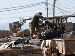 Israeli soldiers arrange their equipment on top of a tank in the Upper Galilee near the Lebanon border on March 2, 2026. Israel bombarded Lebanon on March 2 following rocket fire from Hezbollah, several American warplanes crashed in Kuwait, and Iran lashed out against the region with missiles, as the war with Israel and the United States expanded.