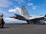 This image provided by U.S. Central Command shows a Navy sailor signaling the launch of an F/A- 18F Super Hornet on the USS Gerald R. Ford (CVN 78) in support of Operation Epic Fury, on Sunday, March 1, 2026. (U.S. Navy via AP)