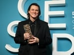 Jim Carrey posed after receiving the Cesar of Honor award during the 51st Cesar Awards ceremony in Paris.(AP)
