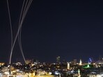 TOPSHOT - Rocket trails from an interception by Israel's Iron Dome missile defence system are pictured over Jerusalem on March 1, 2026. The United States and Israel launched strikes against Iran on February 28, with Israel's public broadcaster reporting that the Iranian supreme leader had been targeted, as the Islamic republic retaliated with barrages of missiles at Gulf states and Israel. (Photo by HAZEM BADER / AFP)