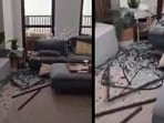 In the clip, broken furniture and shattered glass were seen scattered across the living room floor.