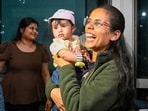 A woman overjoyed as she met her family after an Abu Dhabi flight landed in Delhi on Monday.   