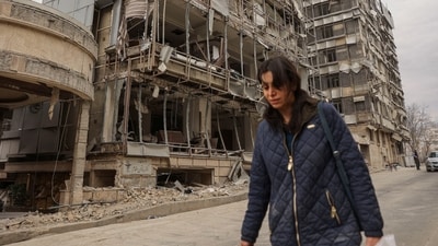 A woman walks on the street following an Israeli and U.S. strike on Gandhi Hotel Hospital, amid the U.S.-Israel conflict with Iran, in Tehran, Iran, March 2, 2026.&nbsp; (via REUTERS)