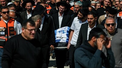 Mourners carry a body at the funeral of a mother and daughter killed in an Iranian missile strike on Sunday, amid the U.S.-Israel conflict with Iran, in a cemetery in Beit Shemesh, Israel March 2, 2026. REUTERS/Nir Elias (REUTERS)