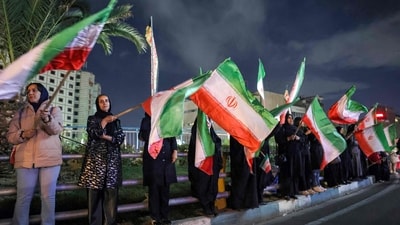 Mourners gather with Iranian national flags for a memorial vigil, a day after the assassination of Iran's supreme leader Ali Khamenei in joint US and Israeli strikes, in Tehran on March 1, 2026.&nbsp; (AFP)