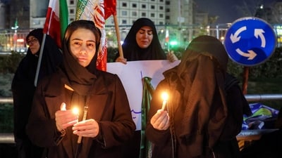Mourners gather with candles for a memorial vigil a day after the assassination of Iran's supreme leader Ali Khamenei, who was killed in joint US and Israeli strikes, in Tehran on March 1, 2026. (AFP)
