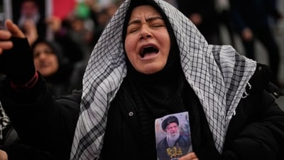 A Demonstrator mourns the death of Iranian Supreme Leader Ayatollah Ali Khamenei while holding his picture during a protest outside the Israeli consulate in Istanbul, Sunday, March 1, 2026. (AP Photo/Khalil Hamra) (AP)