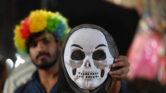 Gram it: It's not just pichkaris and gulal on the Holi shopping list of Gurugrammers! Funky face masks are a hit for Holi festivities, this year too. At the Mandi in Khandsa Road, near Gurugram's HAFED Godown, a shopkeeper shows a horror mask that has become popular among buyers. (Photo: Parveen Kumar/HT)