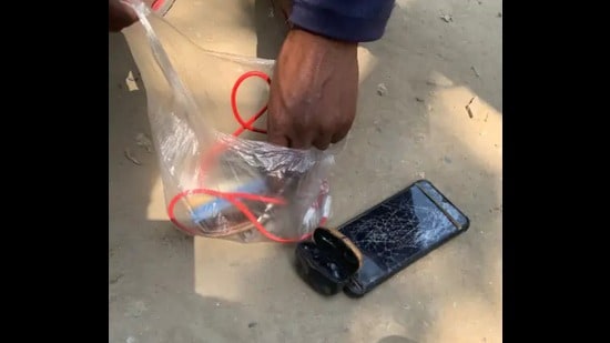 The deceased’s earphones and mobile recovered from the place of accident (HT Photo)