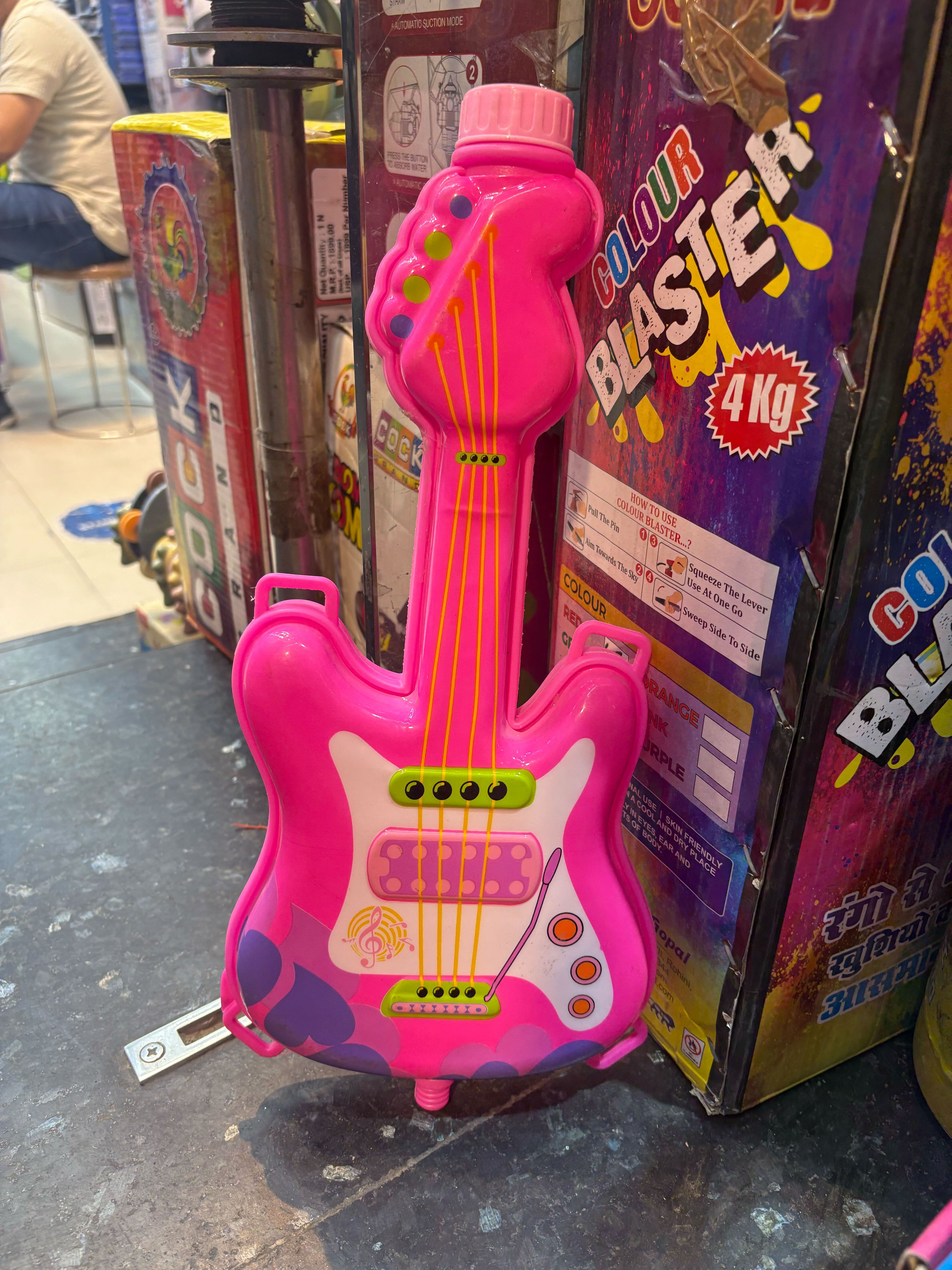 Rock your Holi jam: Strike the perfect musical note with this guitar-shaped pichkari at your Holi party. Price: ₹600 Rock your Holi jam: Strike the perfect musical note with this guitar-shaped pichkari at your Holi party. Price: ₹600