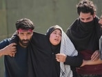 An injured Shiite Muslim woman is taken to medical help during a protest against the killing of Iran's Supreme Leader Ayatollah Ali Khamenei, in Srinagar, Indian controlled Kashmir, Monday, March 2, 2026. (AP Photo/Mukhtar Khan)