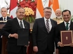 Canadian Prime Minister Mark Carney and Indian Prime Minister Narendra Modi look on as Saskatchewan Premier Scott Moe (centre), Cameco President Tim Gitzel (left) and High Commissioner of India to Canada Shri Patnaik participate in a presentation of agreements in New Delhi on Monday. (AP)