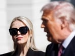 Karoline Leavitt glances at President Donald Trump before departing on Marine One on Feb. 27. 