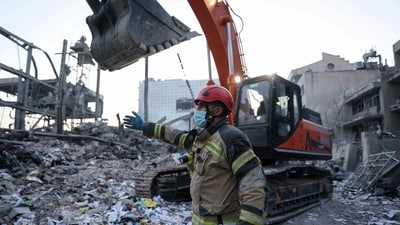 A firefighter gestures next to a heavy machinery amid debris following an Israeli and U.S. strike on a police station, amid the U.S.-Israel conflict with Iran, in Tehran, Iran, March 2, 2026. Majid Asgaripour/WANA (West Asia News Agency) via REUTERS ATTENTION EDITORS - THIS PICTURE WAS PROVIDED BY A THIRD PARTY. (via REUTERS)