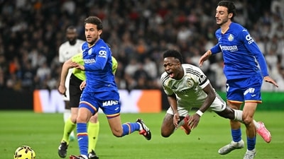 Getafe defender Juan Iglesias (R) fights for the ball with Real Madrid forward Vinicius Junior (C) during the Spanish league football match (AFP) Getafe defender Juan Iglesias (R) fights for the ball with Real Madrid forward Vinicius Junior (C) during the Spanish league football match (AFP)