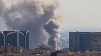 TOPSHOT - Plumes of smoke rise following reported explosions in Tehran on March 1, 2026. Ayatollah Ali Khamenei, Iran's supreme leader since 1989 and sworn enemy of the West, was killed in the opening salvo of a massive US and Israeli attack, sparking a new wave of retaliatory missile strikes from Tehran on March 1. (Photo by ATTA KENARE / AFP) (AFP) TOPSHOT - Plumes of smoke rise following reported explosions in Tehran on March 1, 2026. Ayatollah Ali Khamenei, Iran's supreme leader since 1989 and sworn enemy of the West, was killed in the opening salvo of a massive US and Israeli attack, sparking a new wave of retaliatory missile strikes from Tehran on March 1. (Photo by ATTA KENARE / AFP) (AFP)